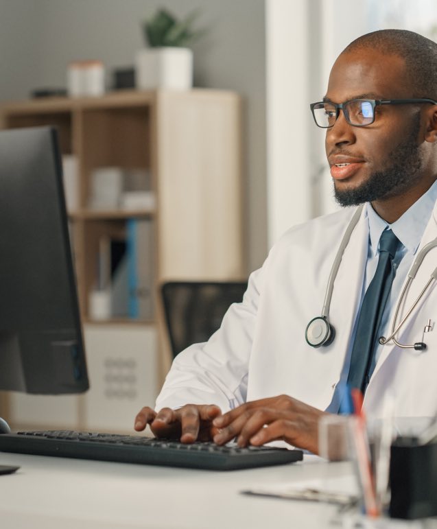 African Male Doctor Working on Computer